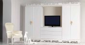 Светлый шкаф с местом под телевизор и кресло