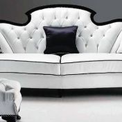 Трехместный диван и мягкий пуф.